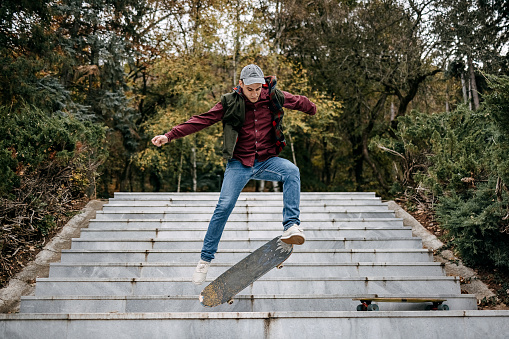 Shot of a young skater skating down a flight of stair