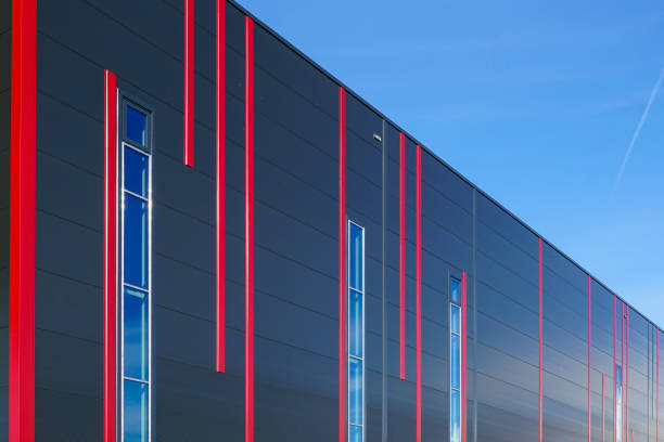 Colorful sandwich panels facade of a new metal construction thermally insulated industrial building Modern design colorful sandwich panels facade with red vertical stripes of a new metal construction thermally insulated industrial building sandwich panel photos stock pictures, royalty-free photos & images