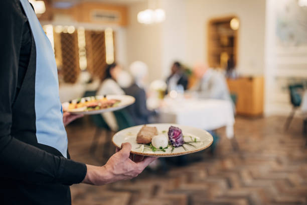 istock Waiter bringing food for guests 1441752431