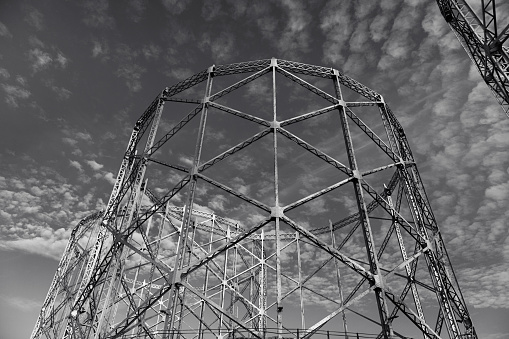 Low angle view of industrial architecture structure metallic skeleton of silo container old fashioned black and white