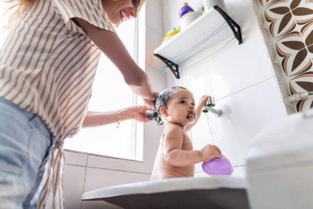 istock Young mother bathing her baby daughter 1441755100