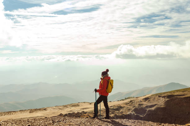 istock Female hiker resting and enjoying the view from a mountain peak 1441755228