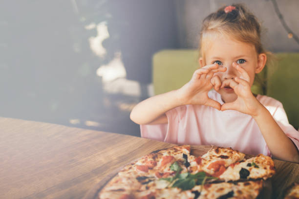 istock Little girl is going to eat pizza. 1441757746