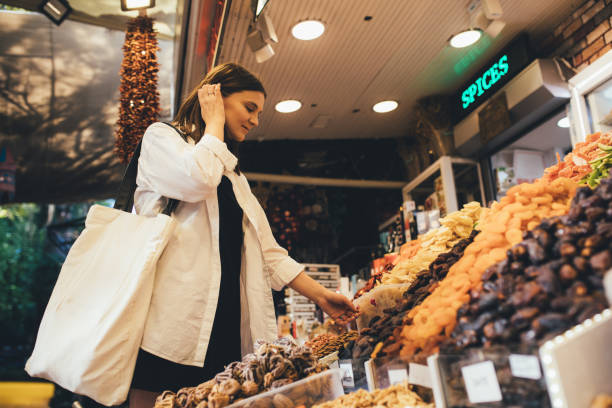 istock Woman on bazaar exploring spices, nuts and delight. 1441757758