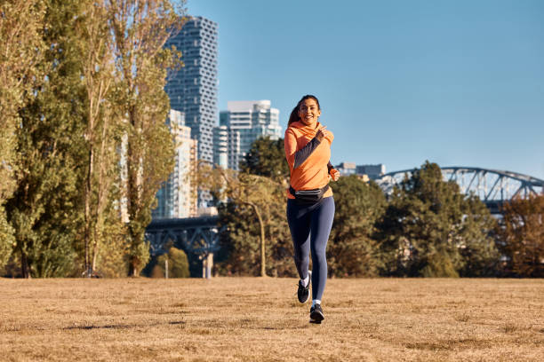 istock Young happy woman running while exercising in nature. 1441759628