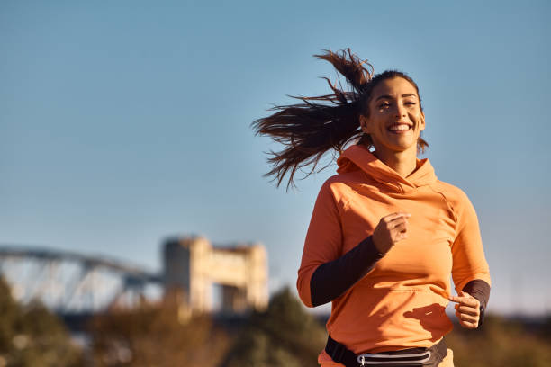 istock Happy female athlete jogging in nature. 1441759635