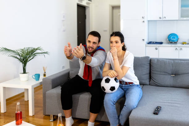 istock Watching excited soccer match at home 1441759654