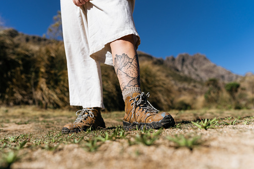 Woman with mountain tattoo on her leg