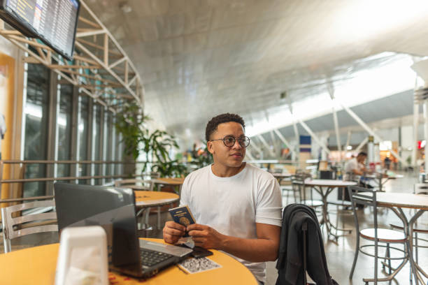 istock Young man checking his passport at the airport 1441762961