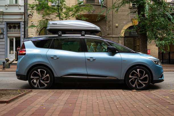 Light blue minivan Renault Grand Scenic 4th generation (2016) with Thule roof rack box on it's top stock photo