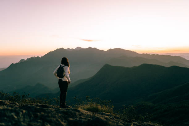 istock Woman enjoying sunset in the mountains 1441763132