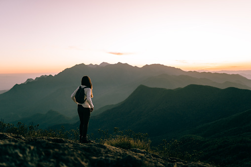 Woman enjoying sunset in the mountains