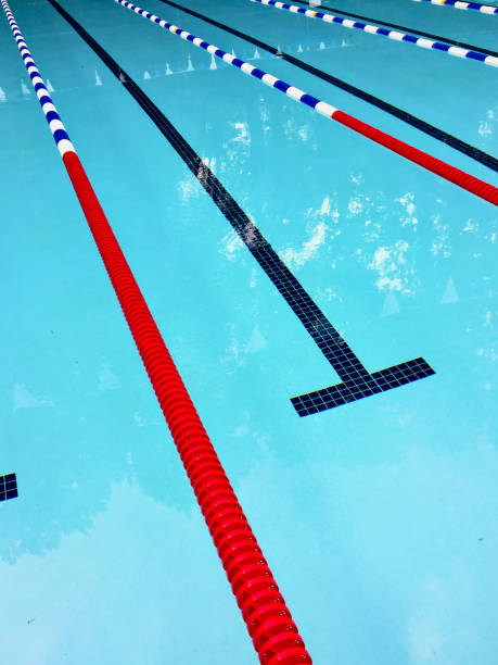 Patterns formed by sunlight on the water in an outdoor swimming pool. No people. Copy space.