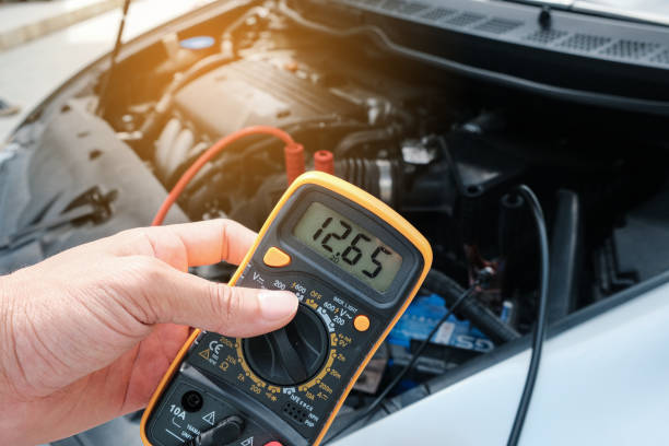 Mechanic hand use multimeter voltmeter to check the voltage level Mechanic hand use multimeter voltmeter to check the voltage level in a car battery. multimeter stock pictures, royalty-free photos & images