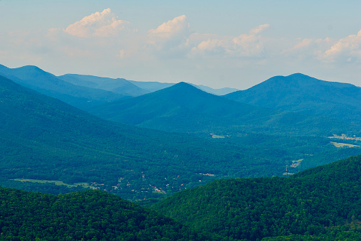 View of a small town in a valley from the Blue Ridge Parkway in Virginia’s Blue Ridge Mountains on a summer day.
