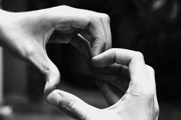 istock Child Making a Heart Shape with his Hands. Monochromatic Black and White Tones 1441769994