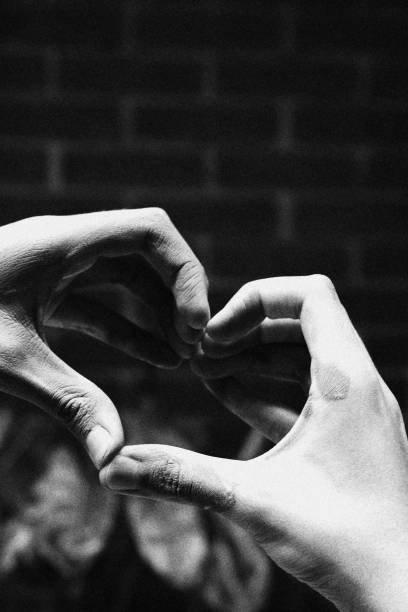 istock Child Making Heart Shape with his Hands. Monochromatic Black and White Tones 1441770018