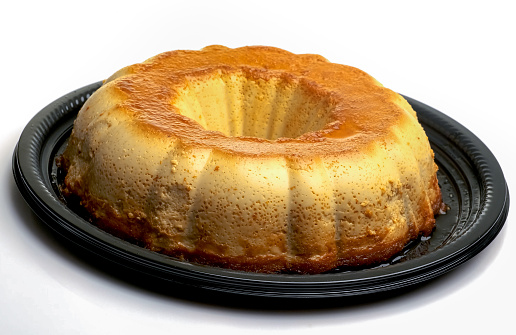 Whole flan on white background (Homemade caramel custard pudding)