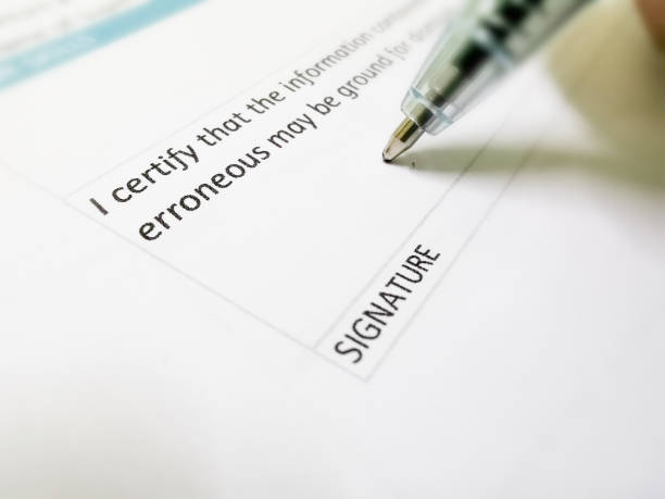istock Close up man hand signing agreement document. 1441772024