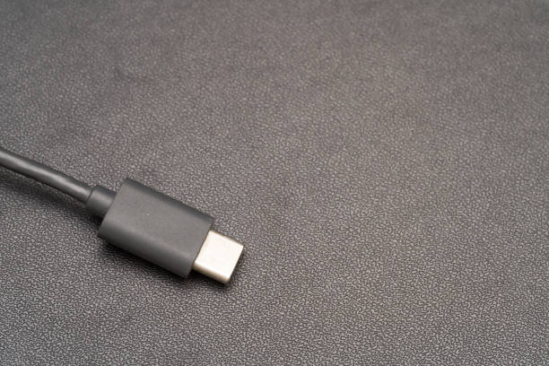 istock Close up of USB Type C connector with a grey cable on a dark background. 1441774468