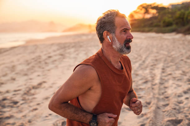 istock An active senior enjoys jogging on the beach 1441774563
