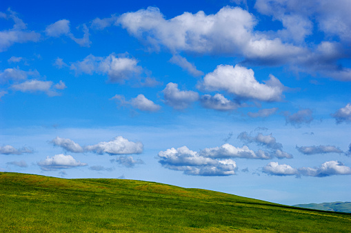 Wide view of green grassy springtime hill, with clouds in the background.

Taken in Central California, USA