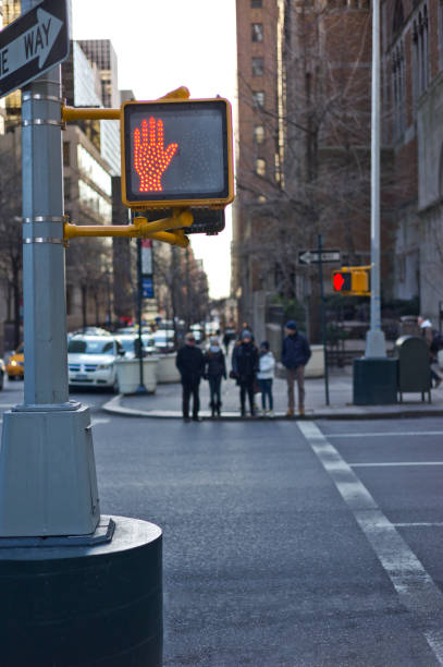 istock Metal pole on a new york corner with red hand lighted sign 1441775947