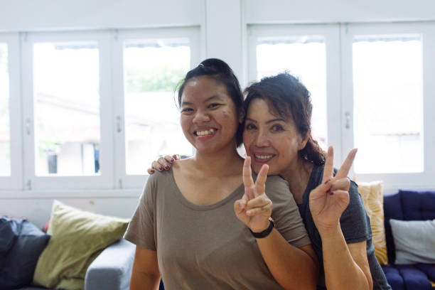 istock Asian Women Giving Peace Sign 1441779833