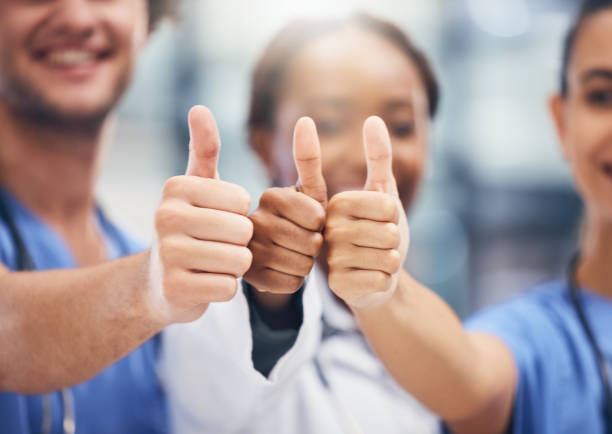 istock Doctors, nurses or thumbs up hands in success, teamwork collaboration or trust with medical winner goal. Zoom on thank you, motivation and vote emoji on man and support women in healthcare hospital 1441786621