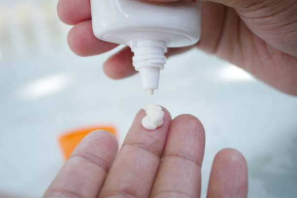 istock Close up of person hand using sunscreen cream 1441798662