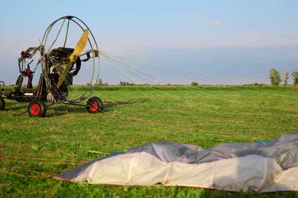 istock paraglider with motor and parachute that provides takeoff and movement in air 1441801829