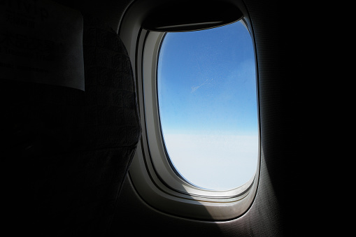 Looking out of the window of the plane