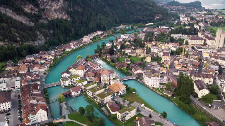 High Angle Pull Back Reveal View of the Aare River Flowing through Interlaken, Switzerland