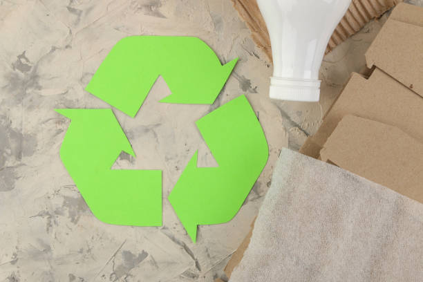 istock Eco symbol. recycling. eco concept on light concrete table. waste recycling. view from above. 1441809714