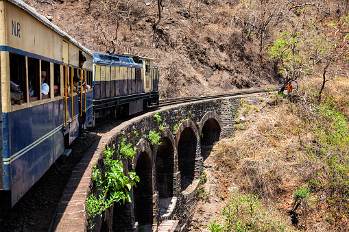 Himachal Pradesh, India - May 12, 2010: Toy train of Kalka Shimla Railway - narrow gauge railway built in 1898 and famous for its scenery and improbable construction. It is UNESCO World Heritage Site