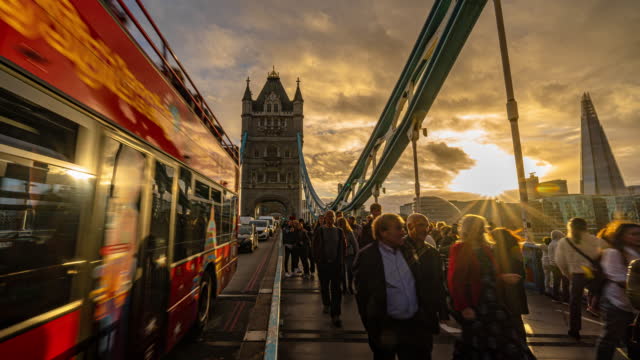Time lapse of Crowded Commuter people walking on the Tower Bridge riverbank can see the shard in downtown district of London