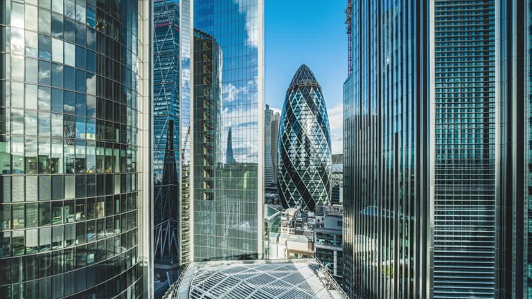 Time lapse of business corporate building skyscraper with the gherkin aka 30 st mark axe and the shard reflection in City of London