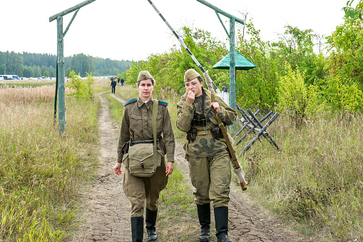 Chelyabinsk, Russia, August 28, 2021 reconstruction of the events of the Second World War. Women in Soviet military uniforms pass through the security post