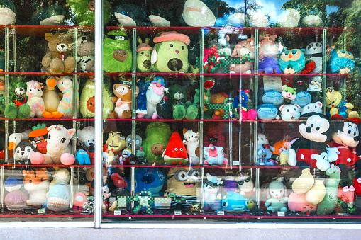 Chelyabinsk Russia July 21 2022 a glass showcase of a soft toy store with a discount. Sale of retro toys