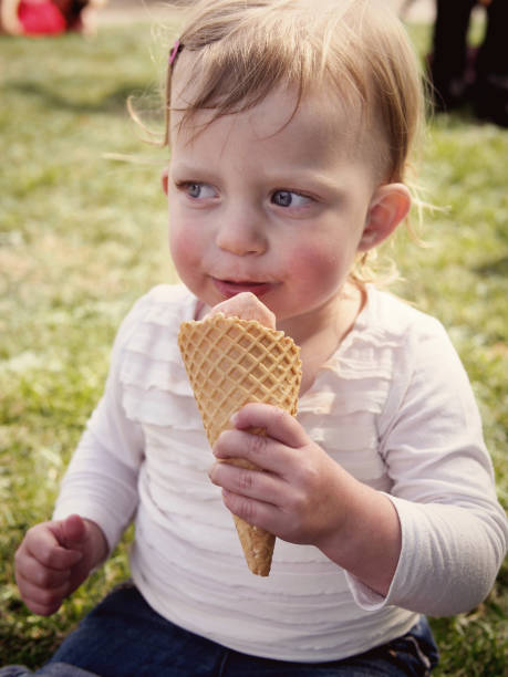 istock Young girl eating ice cream 1441820405