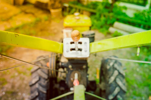 A rusty exhaust pipe on a tractor's hood signifies aging machinery and the relentless work of farming
