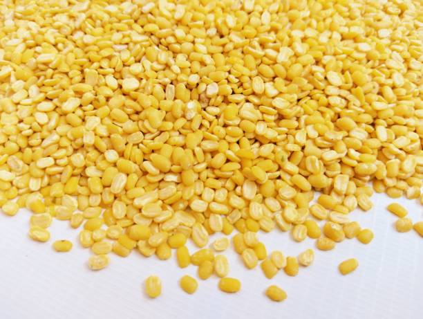 Skinned and split green gram yellow moong dal lentils mung beans pulse food sabatmoong mungpea peeled without husk splitmung skin removed moongdaal in a bowl closeup view image stock photo stock photo