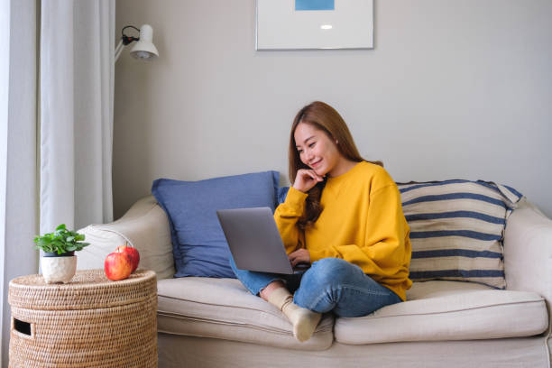 istock Portrait image of a young woman using laptop computer for working or studying online at home 1441823215