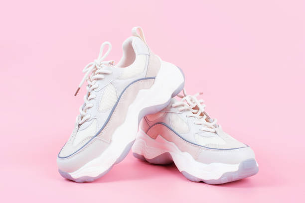 istock Pair of sneakers on pink background close-up side view. 1441825067