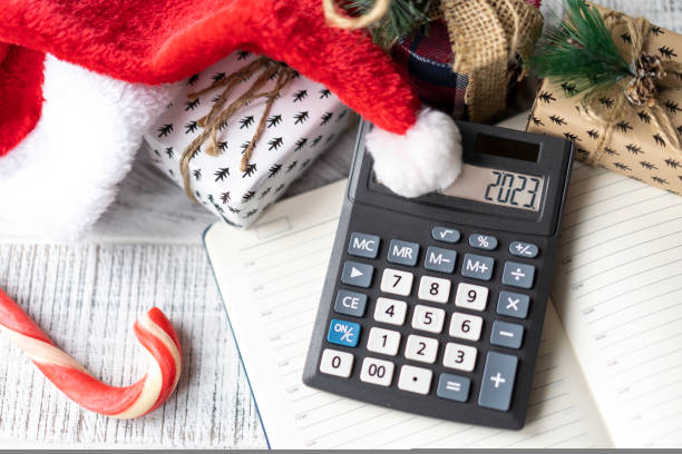 istock New Year's layout with calculator, Santa's hat and Christmas decorations 1441828302