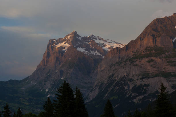 Dramatic light illuminates an epic mountain scene in the Jungfrau region of the Swiss Alps.