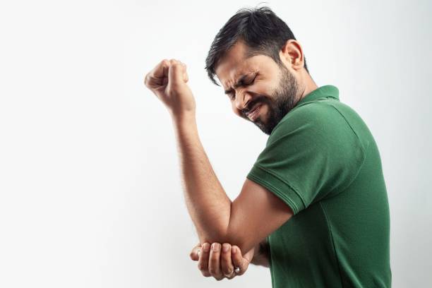 istock single person showing elbow injury pain concept with grimace expression 1441830788