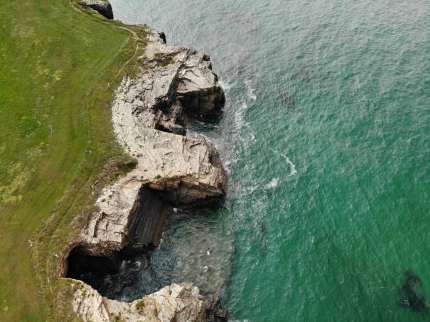 istock Aerial view of a turquoise ocean with cliff on the side 1441831149