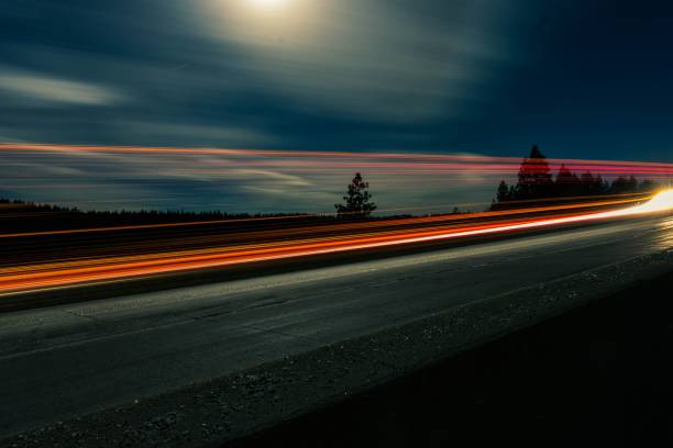 istock View of road with light trails in night 1441831630