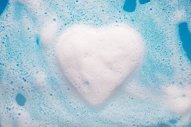 istock Heart-shaped foam over blue water with copy space. 1441832195